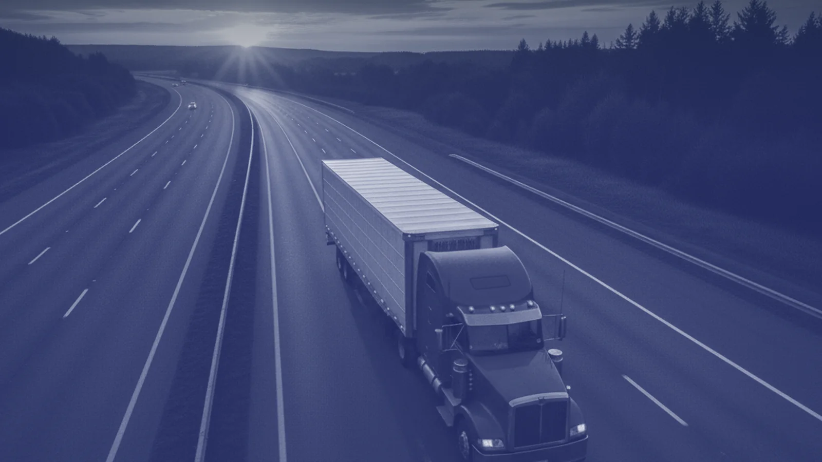 A truck on a highway at dusk, in the Arrcing Transport blue